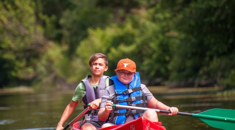 2 kids canoeing and enjoying the benefits of nature at YMCA Camp Moody